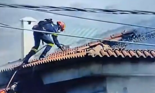 Πυροσβέστης πάνω σε σκεπή παλαιά φώκαια